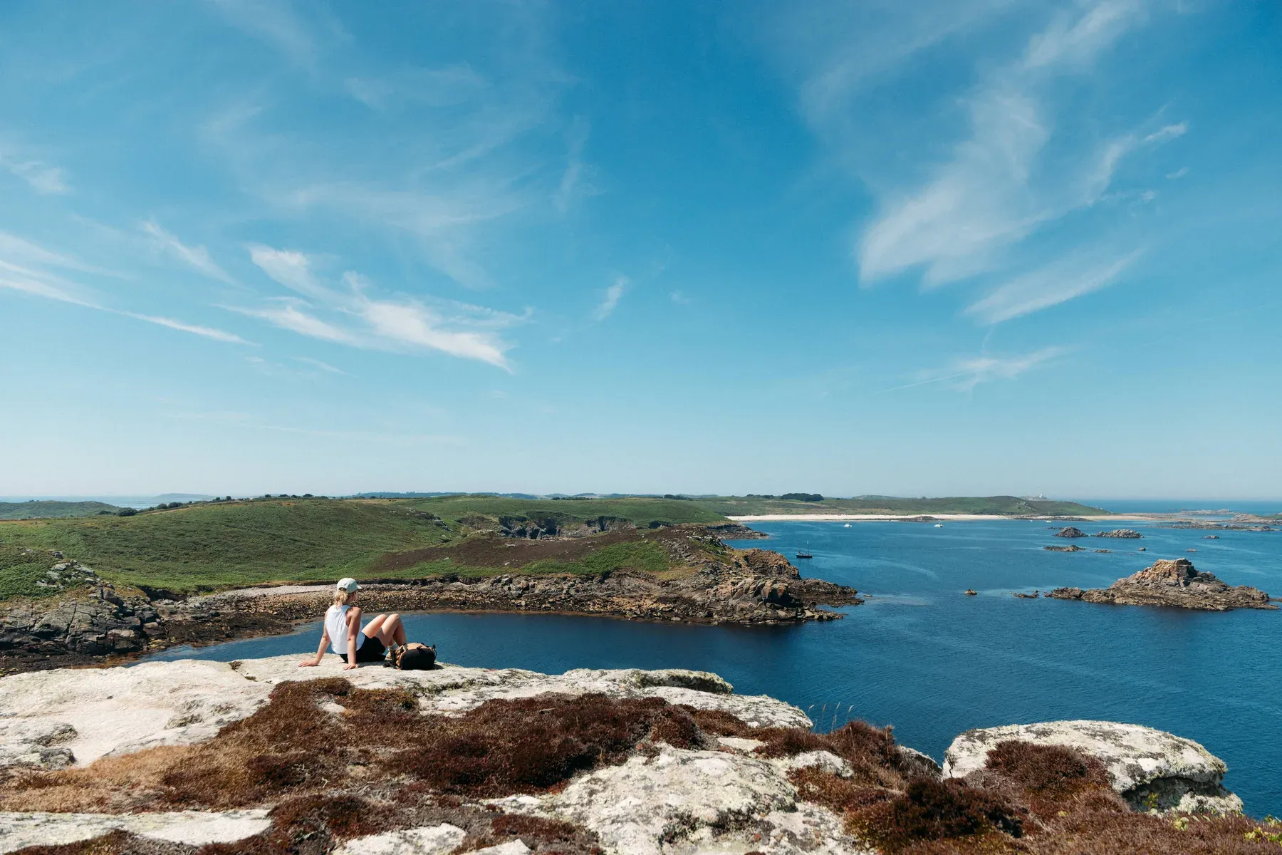 Lydia Cooke overlooking the coast of St Martin's during an Isles of Scilly Travel destination shoot.